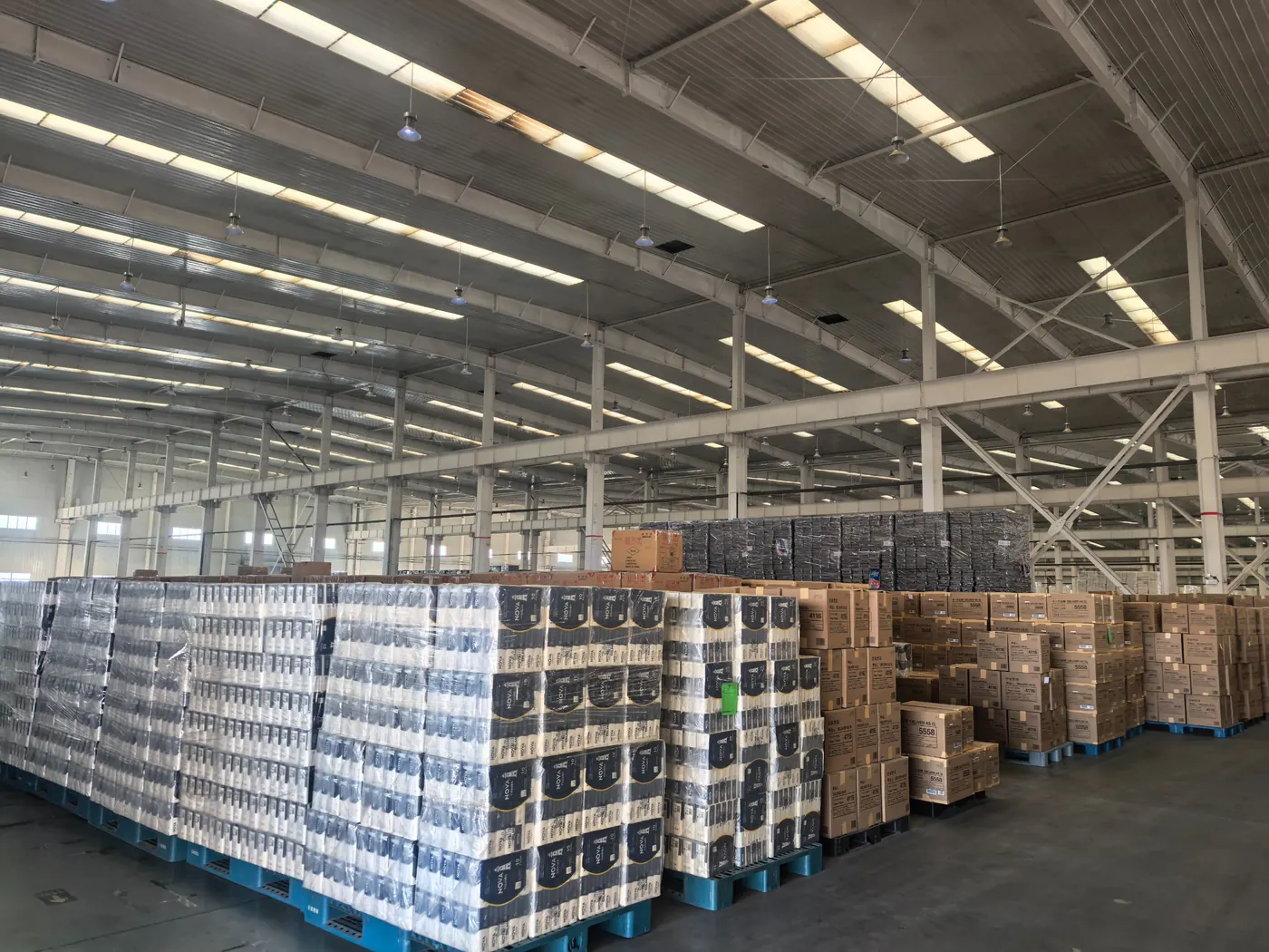 Pallets of Nova Tissues stock in a large distribution warehouse, ready for shipment